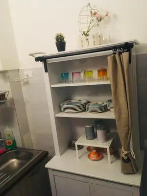 a kitchen cupboard with plates and dishes on it at Around Cassaro Holiday House in Palermo