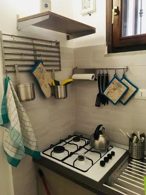 a kitchen with a stove top oven in a kitchen at Around Cassaro Holiday House in Palermo