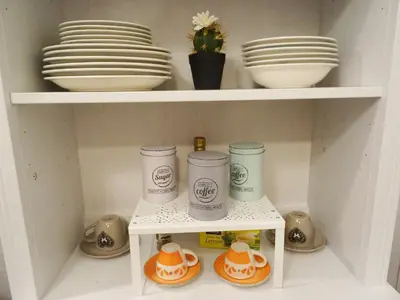 a white shelf with plates and bowls in a kitchen at Around Cassaro Holiday House in Palermo