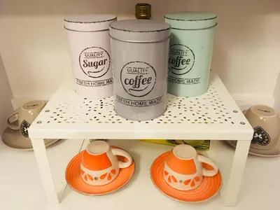 a shelf with four coffee cups on it at Around Cassaro Holiday House in Palermo