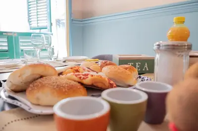 a plate of pastries sitting on a table with drinks at Al teatro Massimo in Palermo