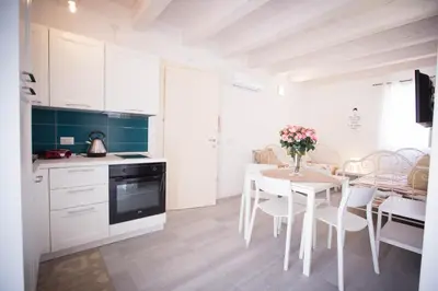 a kitchen and dining room with a table and chairs at Sciabika Home - Edificio Eolie in Castellammare del Golfo