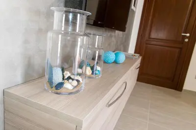 two glass vases with fishes in them on a counter at Casa Vacanze Fontana in San Vito lo Capo