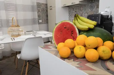 a pile of fruit on a counter in a kitchen at Reginella B&B Palermo in Palermo