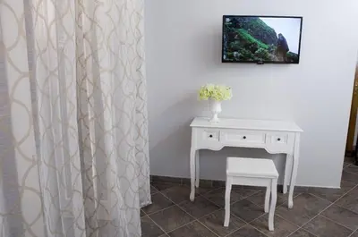 a table and a chair next to a white desk at Reginella B&B Palermo in Palermo