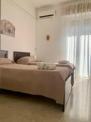 a bedroom with two beds with towels on them at Appartamento al centro vicino il porto in Palermo