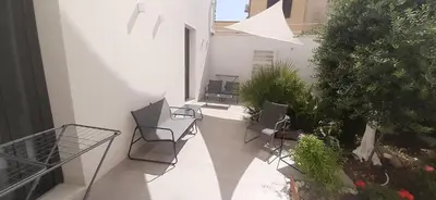 a balcony with chairs and plants on a building at Patio 101 
