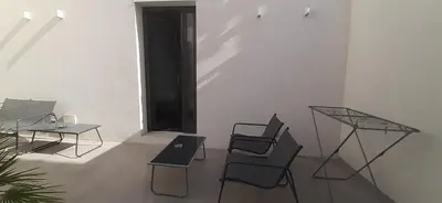 a room with chairs and tables and a window at Patio 101 