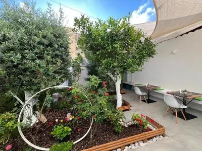 a garden with trees and flowers in a room at Patio 101 
