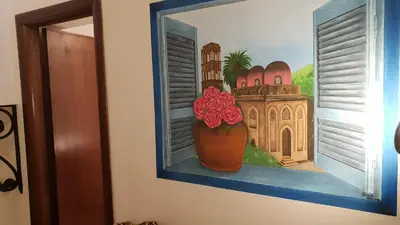 a painting of a vase with flowers on a wall at Le Stelle del Massimo in Palermo