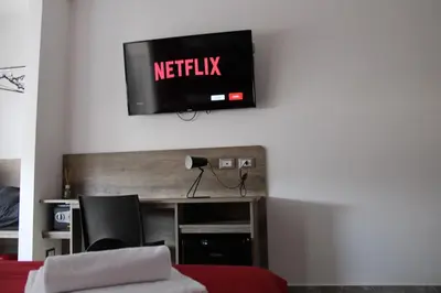 a tv hanging on a wall in a room at B&B D'Amari Affittacamere in Palermo