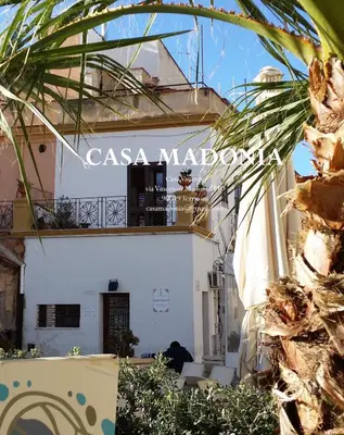 a white building with a sign that reads casa madrococo at Casa Madonia in Terrasini