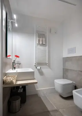 a white bathroom with a sink and a toilet at Casa Madonia in Terrasini
