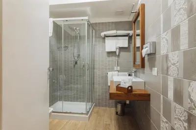 a bathroom with a glass shower and a sink at Le Vele di Balestrate in Balestrate