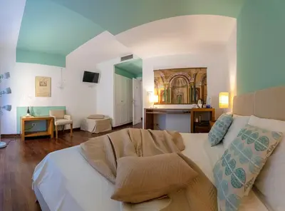 a living room with a white couch in a room at Hotel Pocho in San Vito lo Capo