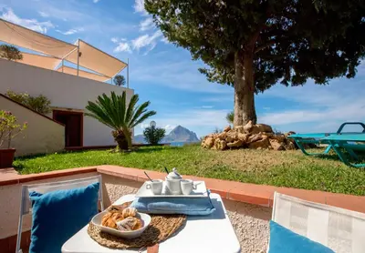 a white table with a bowl of food on it at Hotel Pocho in San Vito lo Capo