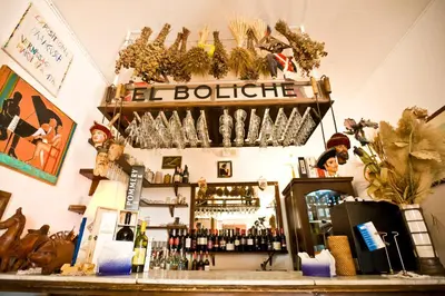 a bar with a shelf with wine glasses on it at Hotel Pocho in San Vito lo Capo