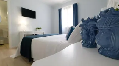 a bedroom with a bed with a statue on it at La Via dell'Acqua in Macari