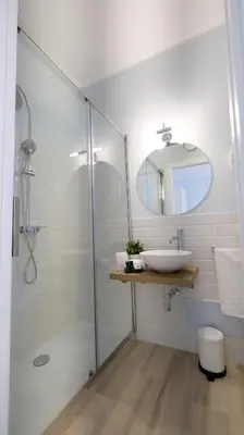 a bathroom with a glass shower and a sink at La Via dell'Acqua in Macari