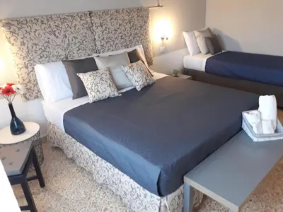 a room with a bed and a table with flowers on it at 5 cupole in Palermo