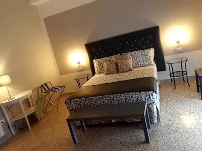 a bedroom with a large bed and a window at 5 cupole in Palermo