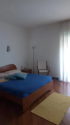 a living room with a blue couch and a rug at A casa di Elena in Alcamo