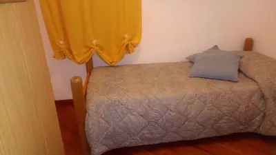 a room with a table with a vase of flowers on it at A casa di Elena in Alcamo