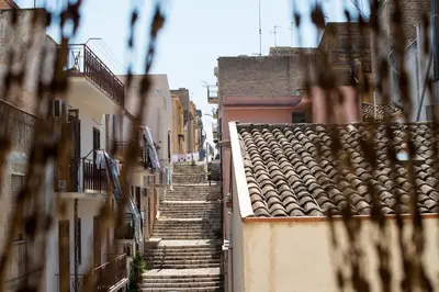 an alley with stairs and buildings in a city at Casa vacanze Mare Nostrum in Castellammare del Golfo