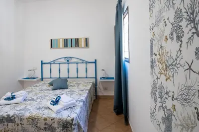 a bedroom with a bed with towels on it at Casa vacanze Mare Nostrum in Castellammare del Golfo