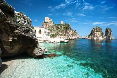 a view of a beach with rocks and the water at Casa vacanze Mare Nostrum in Castellammare del Golfo