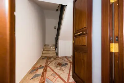 a hallway with a door and a tile floor at Casa Mariú in Castellammare del Golfo