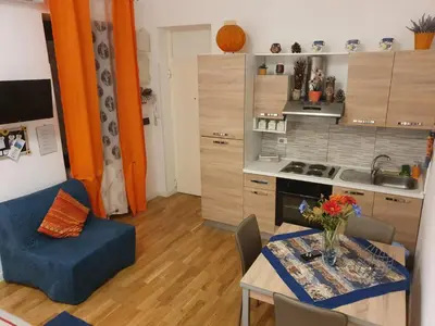 a kitchen and a dining room with a table and a dining room at La Casetta in Palermo
