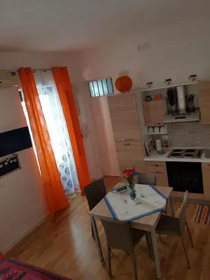 a kitchen with a table and chairs in a room at La Casetta in Palermo