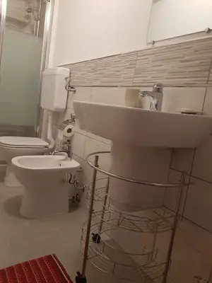 a bathroom with a sink and a toilet at La Casetta in Palermo