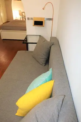 a couch with pillows on it in a room at Palermo Home White Home in Palermo