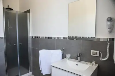 a bathroom with a sink and a shower at Piano Monaco in Carini