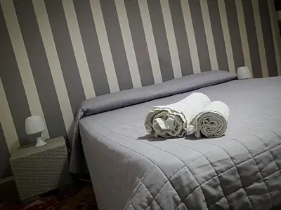 a bedroom with a bed with two towels on it at Al Civico 8 - Palermo in Palermo