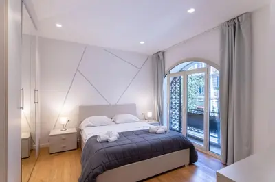 a bedroom with a bed and a large window at Central Mezzanine in Palermo