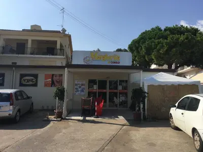 a building with a car parked in front of it at Villa dei Limoni sul Mare in Castellammare del Golfo