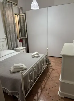a bedroom with a bed with two towels on it at Villa dei Limoni sul Mare in Castellammare del Golfo