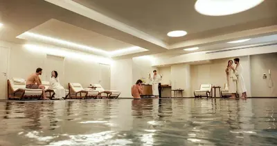 a group of people in a waiting room with water on the floor at Borgo degli Angeli Wellness & Resort by Le Dhome Sicily in Balestrate