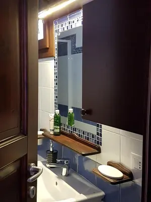 a bathroom with a sink and a mirror at Casa Vacanze Villa D'Orleans in Palermo