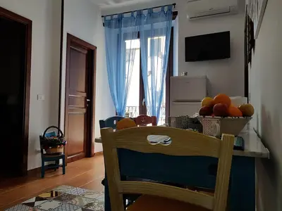 a kitchen with a table with a bowl of fruit on it at Casa Vacanze Villa D'Orleans in Palermo