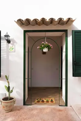 a room with a glass door with a potted plant at Baglio Reale Apartments in Palermo