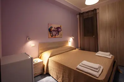 a small bedroom with a bed with two towels on it at Affittacamere da Noemi in Castellammare del Golfo