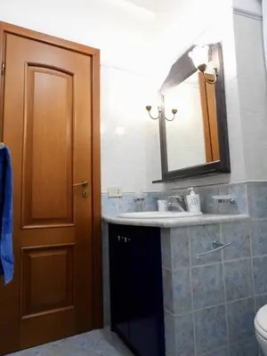 a bathroom with a sink and a mirror and a toilet at B&B Maria Piddu in Palermo