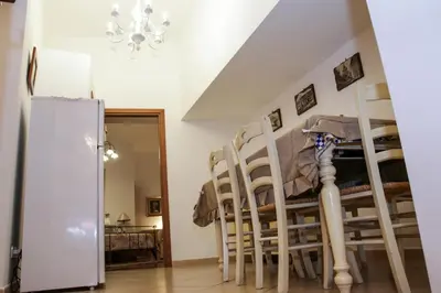 a dining room with chairs and a refrigerator at B&B Maria Piddu in Palermo