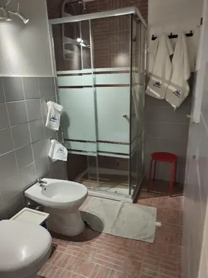 a bathroom with a toilet and a glass shower at Elegant Villa with Private Pool in Alcamo Marina – Sea View in Alcamo Marina