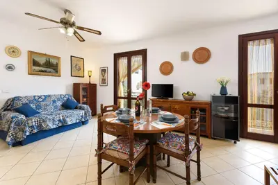 a living room with a blue couch and a table at Casa Marisa in San Vito lo Capo