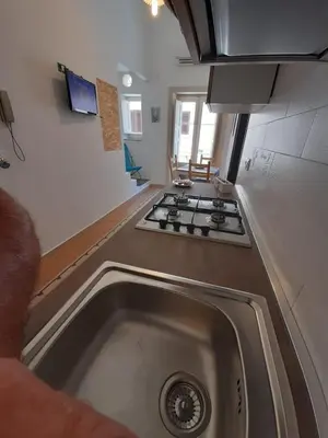 a kitchen with a sink and a stove at Casa Vacanze Mannina in Castellammare del Golfo
